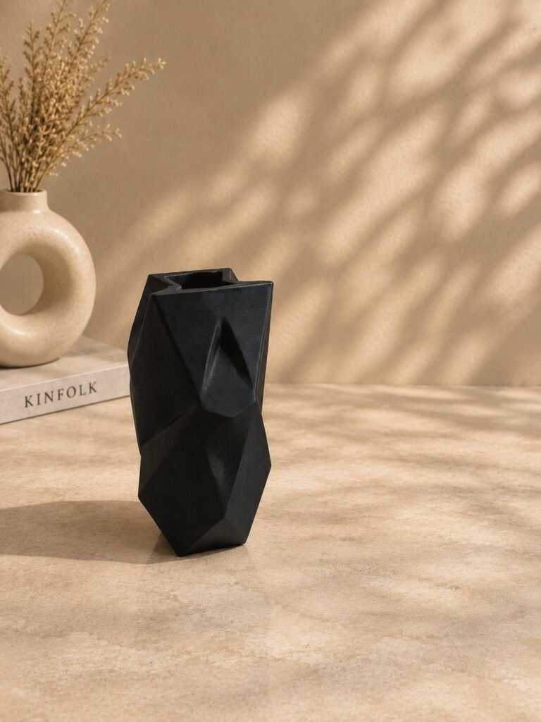 Geometric Facet Sculptural Vase in black on a warm neutral surface