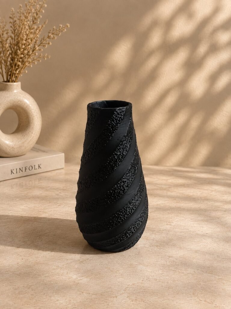 Spiral Texture Sculptural Vase in black on a warm neutral surface